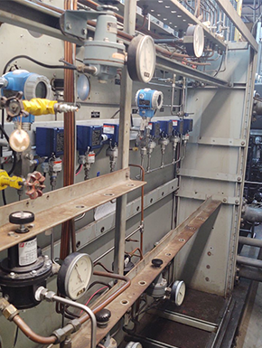 Instrumentation panel in an Ohio power plant, featuring pressure gauges, control valves, and monitoring devices for system regulation.