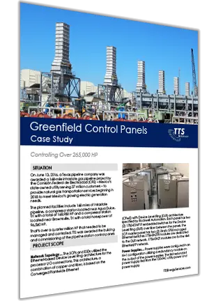 Industrial facility with control panels and large structures on a clear day.