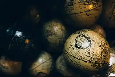 Vintage globes showcasing detailed world maps under soft lighting.