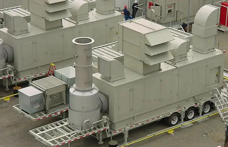Industrial mobile generator units with ventilation systems on a trailer.
