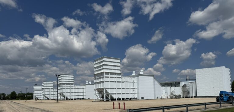 Siemens 501D5A SGT-6-3000E Gas Turbines under a blue sky with clouds