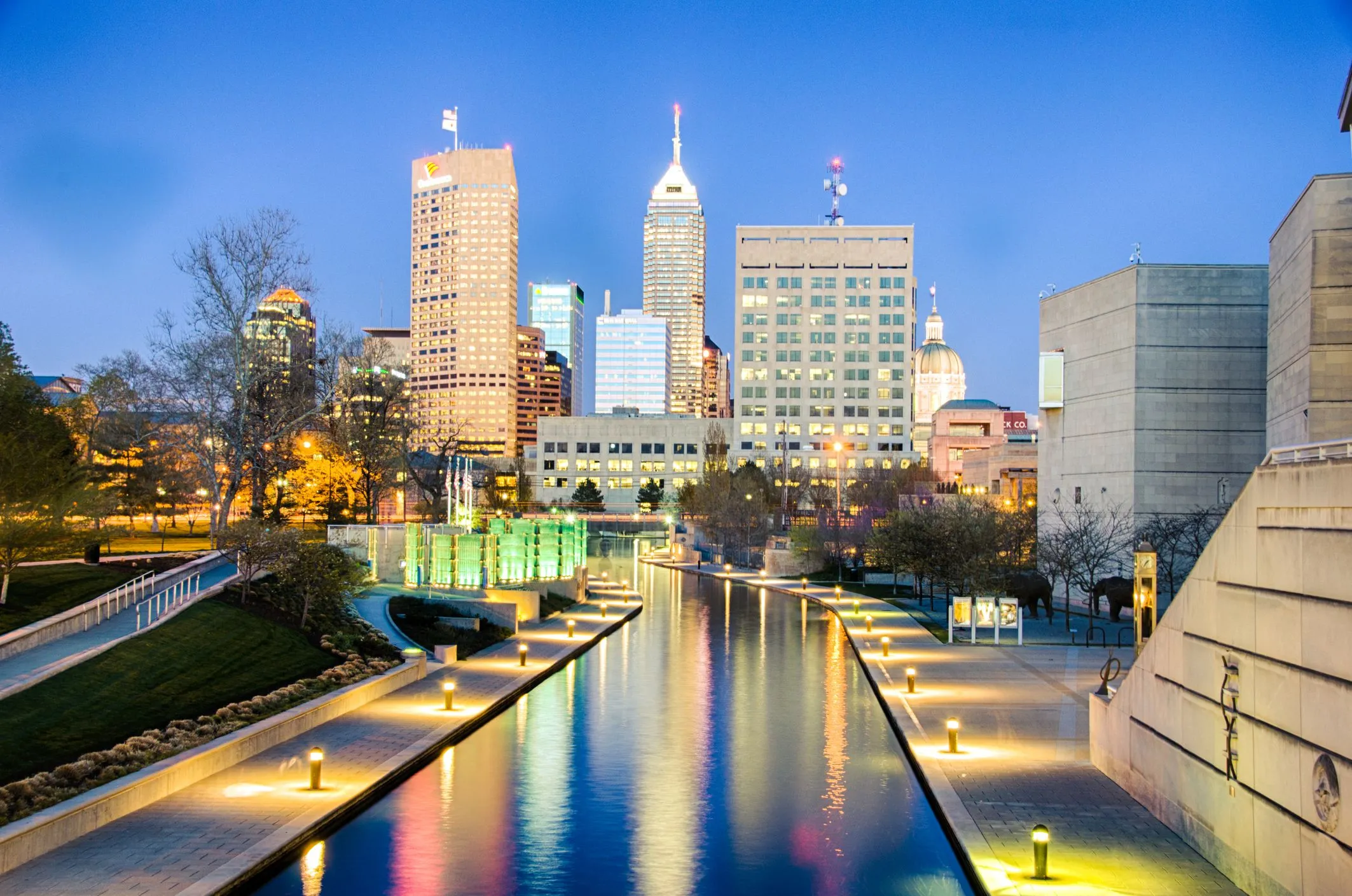 Indianapolis skyline with canal and lights at dusk