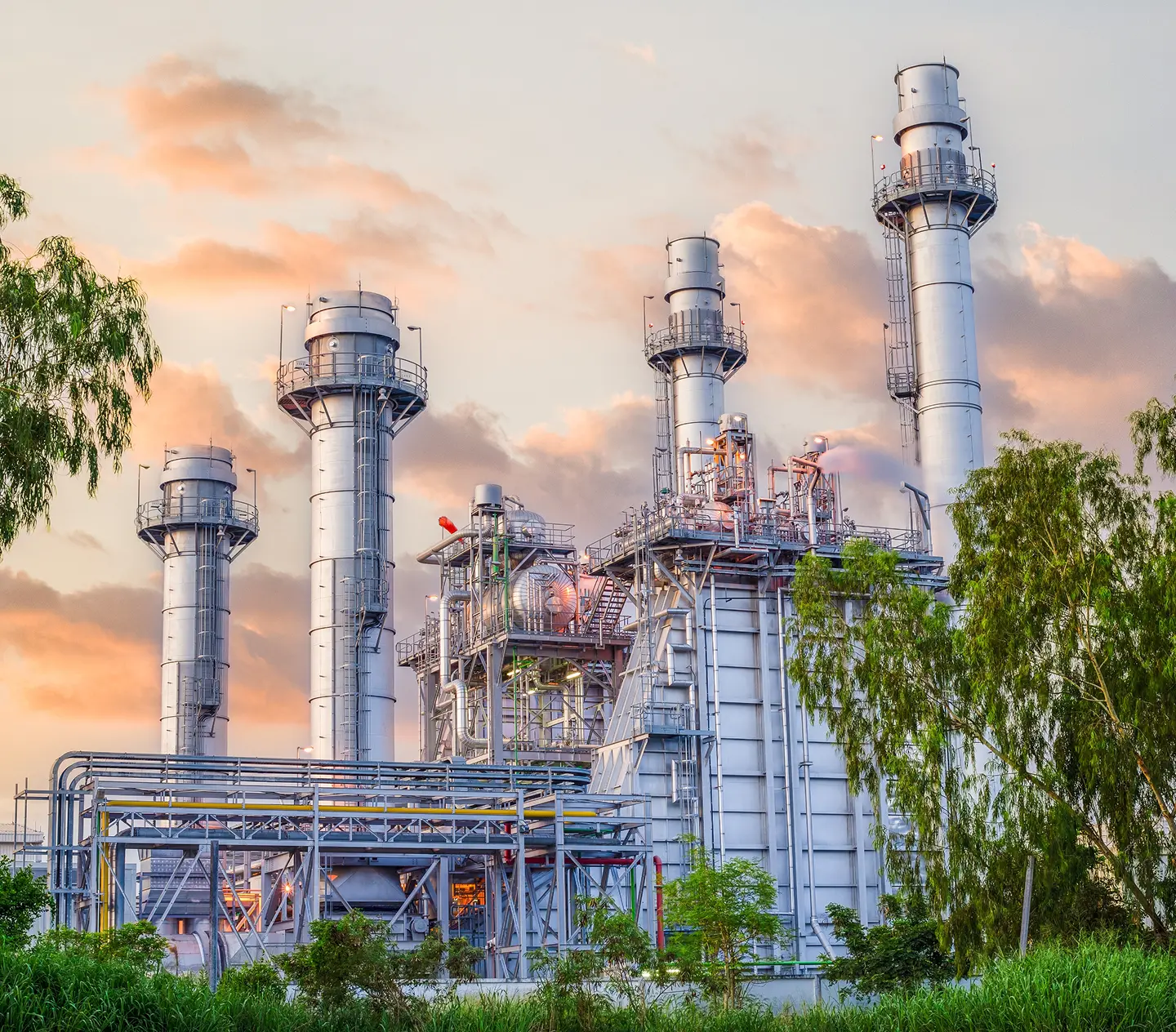 Power plant with tall chimneys and greenery